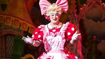 Pantomime dame on stage, mid-performance