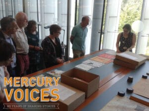 Group viewing documents with Hannah with logo