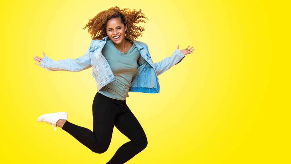 18-25s MYC image - girl jumping on yellow background
