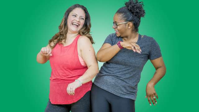 Musical Theatre Dance - two women dancing together and laughing with a green background.
