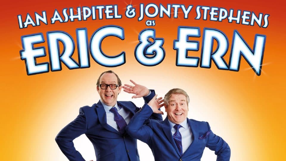 Eric and Ern stand together in a classic Morecambe and Wise pose with the name of the show above them