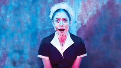 Ladykiller - a photo of a woman in a maid's costume with a surprised look on her face and she is covered in blood spatter