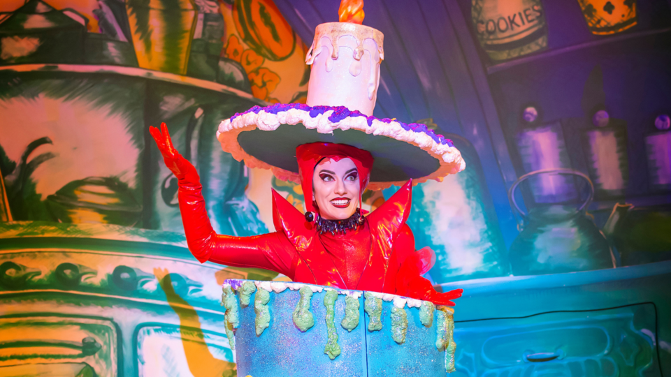 Jaimie Pruden as Carabosse coming out of a cake