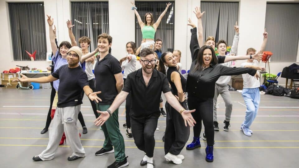Cast members posing during rehearsals