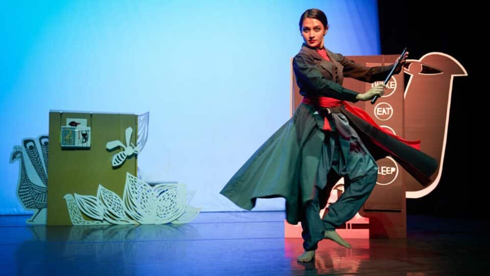 Cast member pictured in a pose while performing
