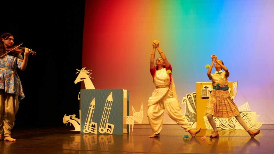 Cast members pictured in a pose while performing