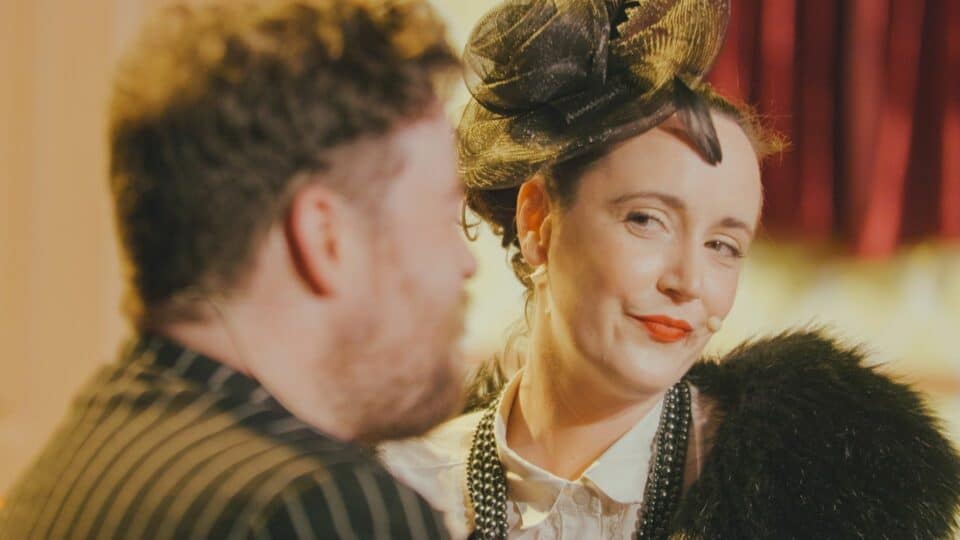 Woman smirking while looking at a man