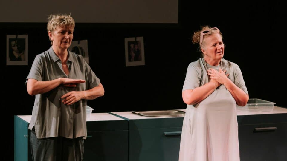 Two women in the middle of performing
