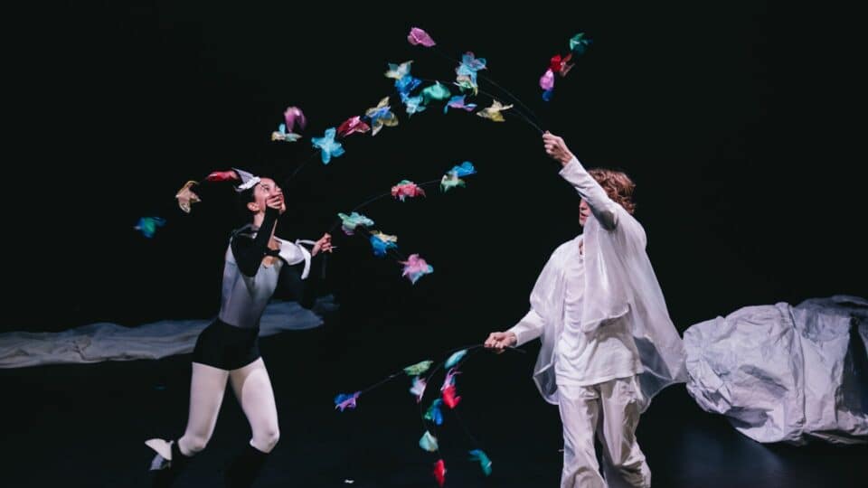 Image from skydiver showing feather butterflies attached to a string held by a man and a woman