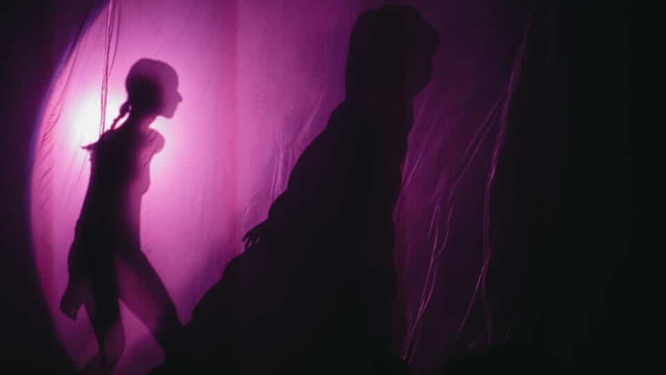 Image from skydiver showing a shadow behind the purple screen of a young woman